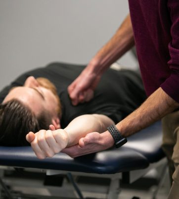 man receiving therapy on arm