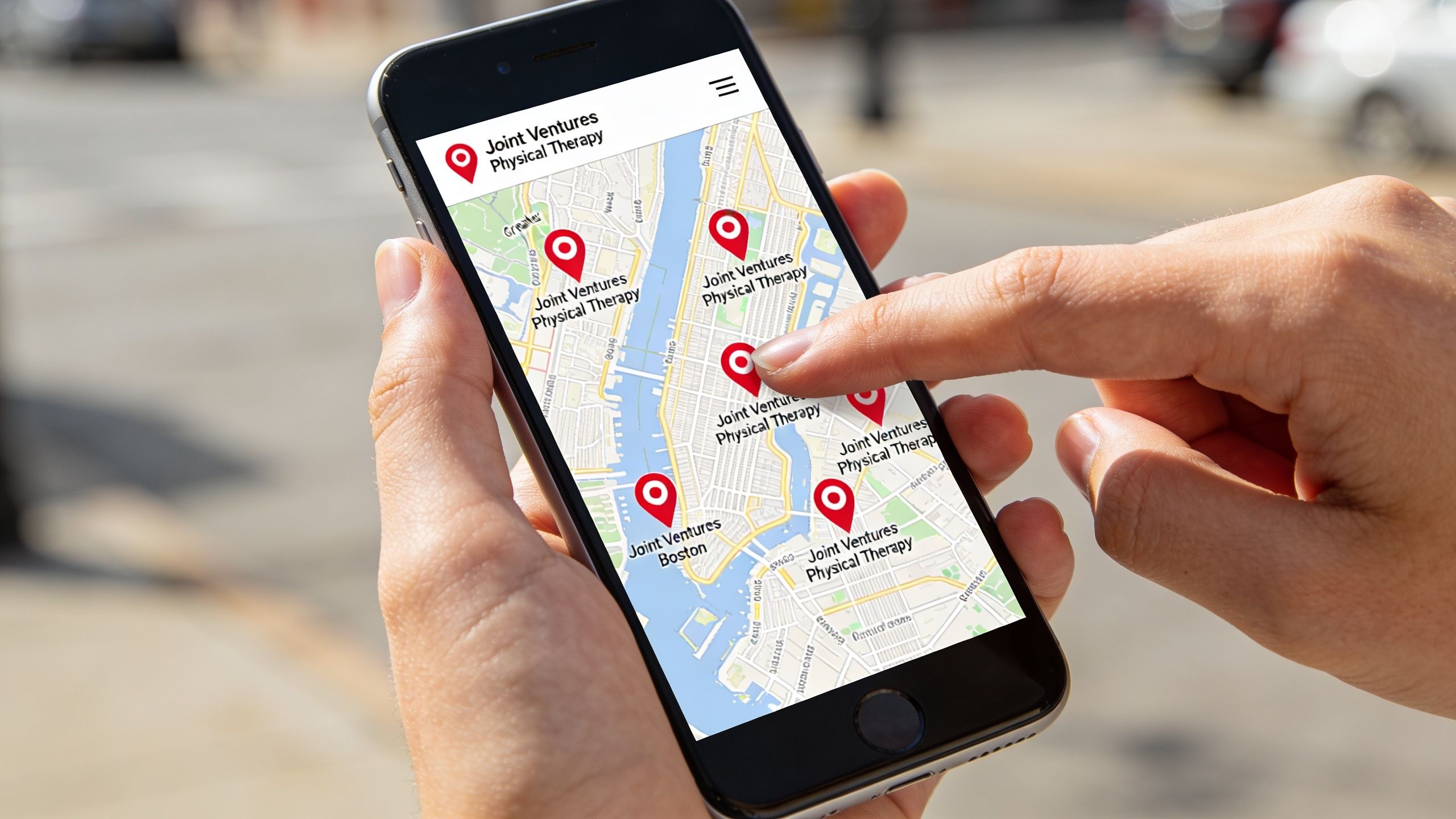 A person using a smartphone to view multiple Joint Ventures Physical Therapy locations on a map.